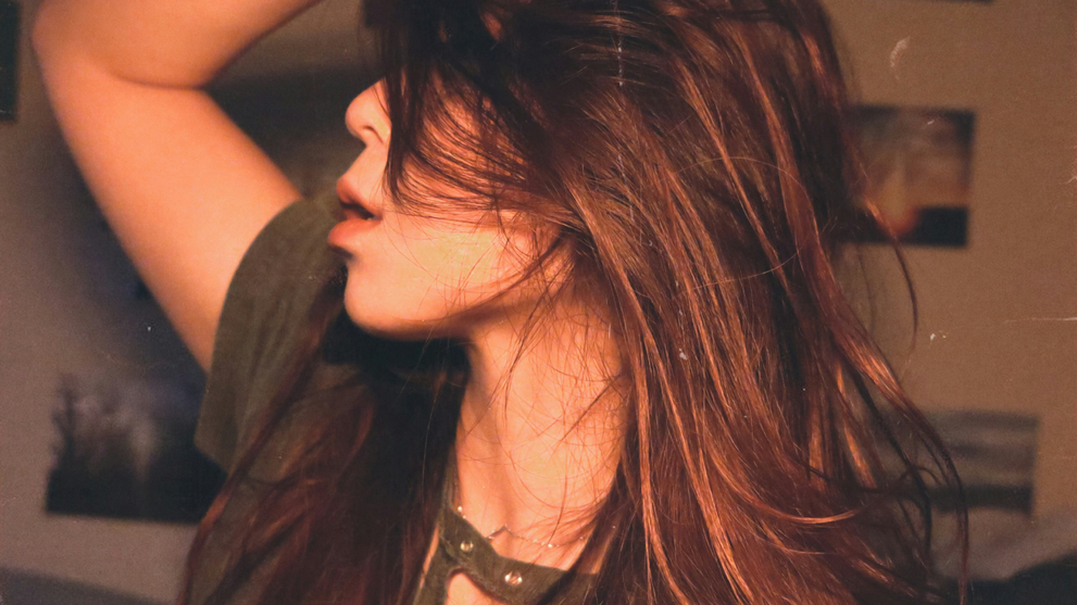 Woman Posing With Shiny Brown Hair