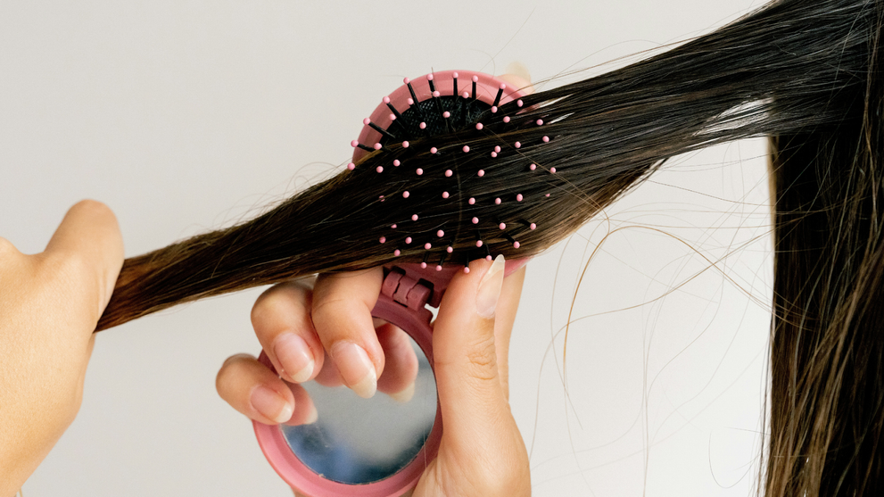 Women With Long, Brown Hair, Brushing Her Damp Hair